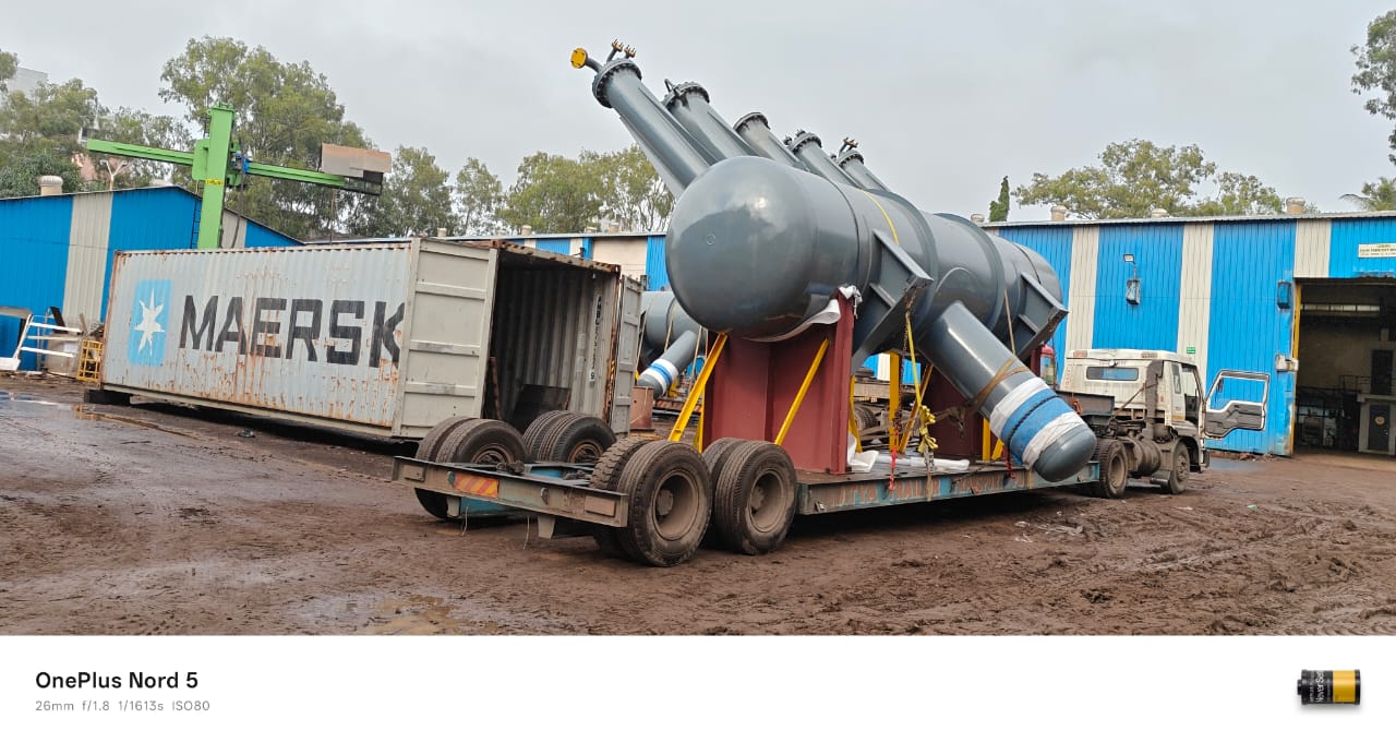 Large industrial process vessel loaded on low-bed trailer for heavy cargo transport