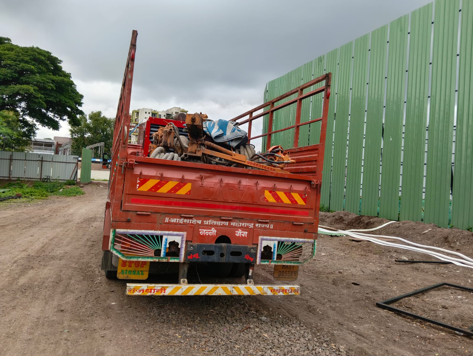 Open truck carrying industrial machinery for dedicated full truck load transport