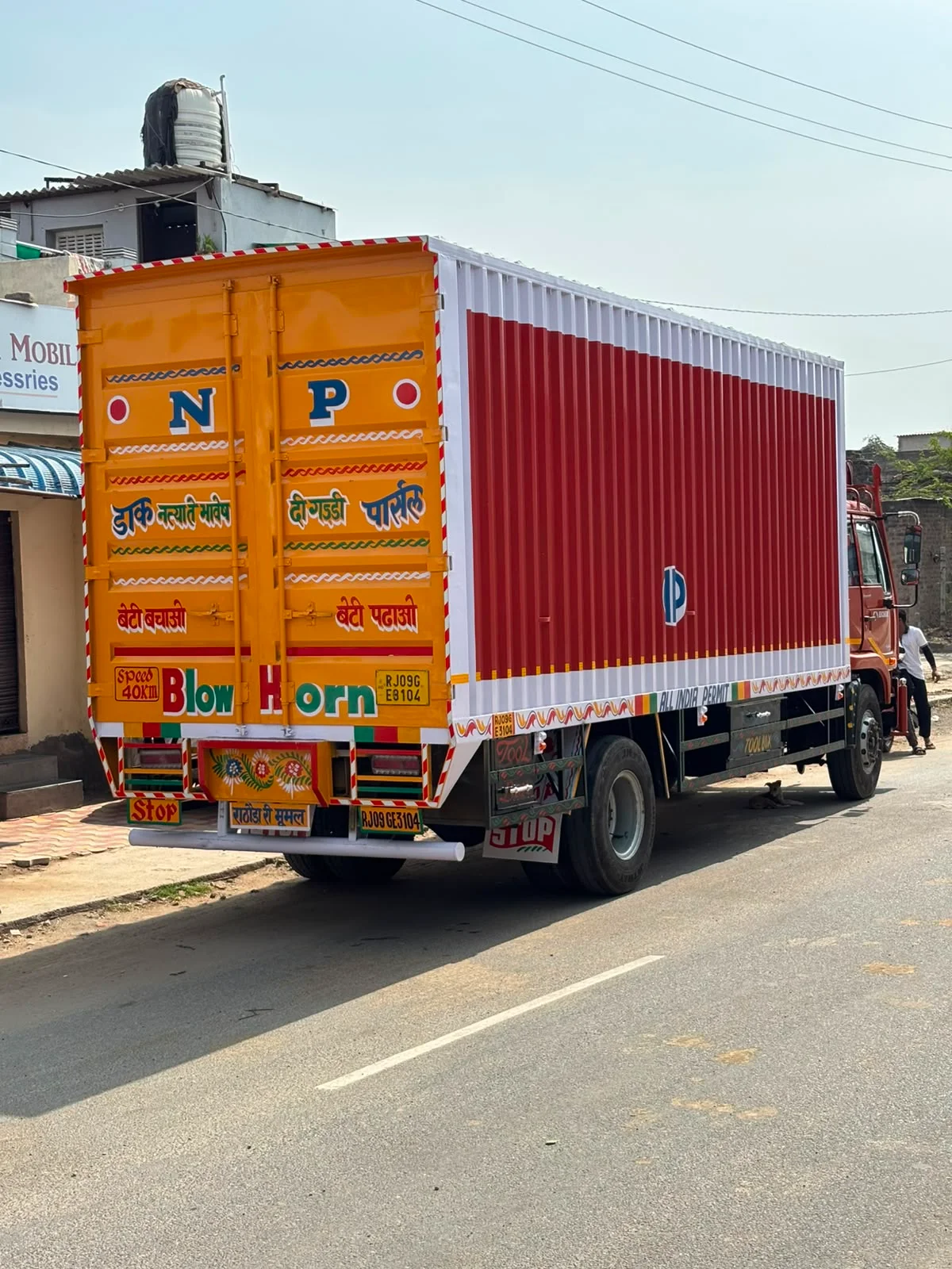 32 Ft Truck Booking in Pune | SXL & MXL 3 Large red and white closed-body container truck viewed from the rear